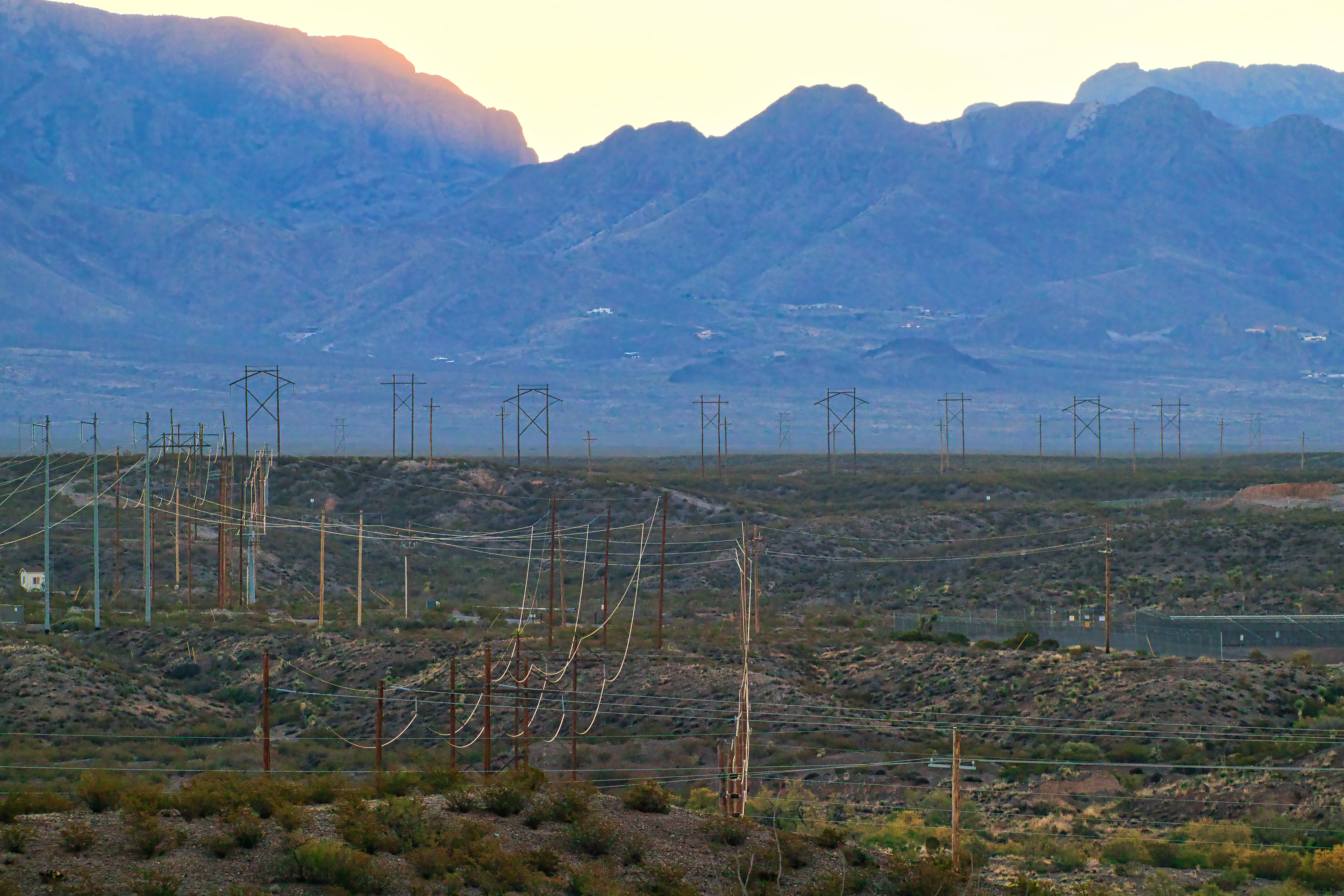 A mountain range with power lines in the distance.